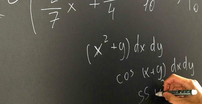 person doing math on a chalkboard