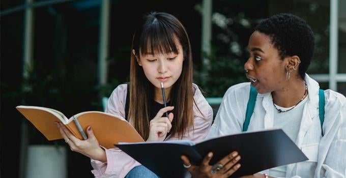 people looking at notebooks